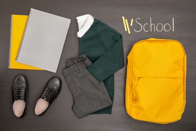 Photo of School uniform on wooden background, top view