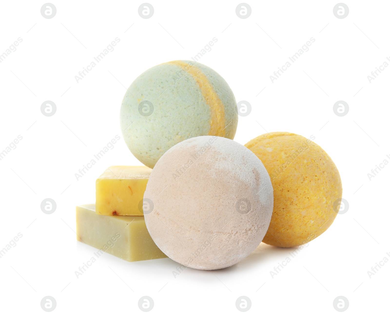 Photo of Bath bombs and soap bars on white background