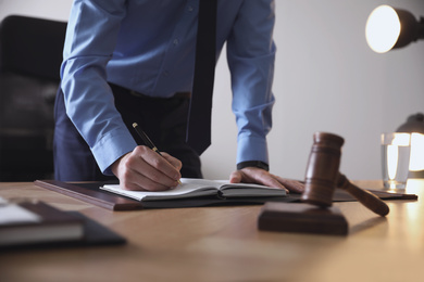 Male lawyer working at table in office, closeup