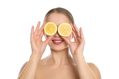 Photo of Young woman with cut lemon on white background. Vitamin rich food