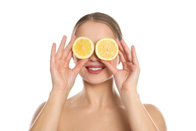 Young woman with cut lemon on white background. Vitamin rich food