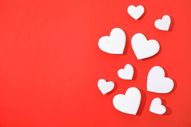 Photo of Small paper hearts on color background, top view