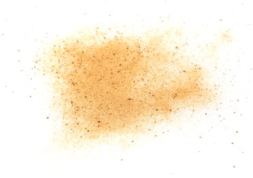 Photo of Pile of brown dust scattered on white background