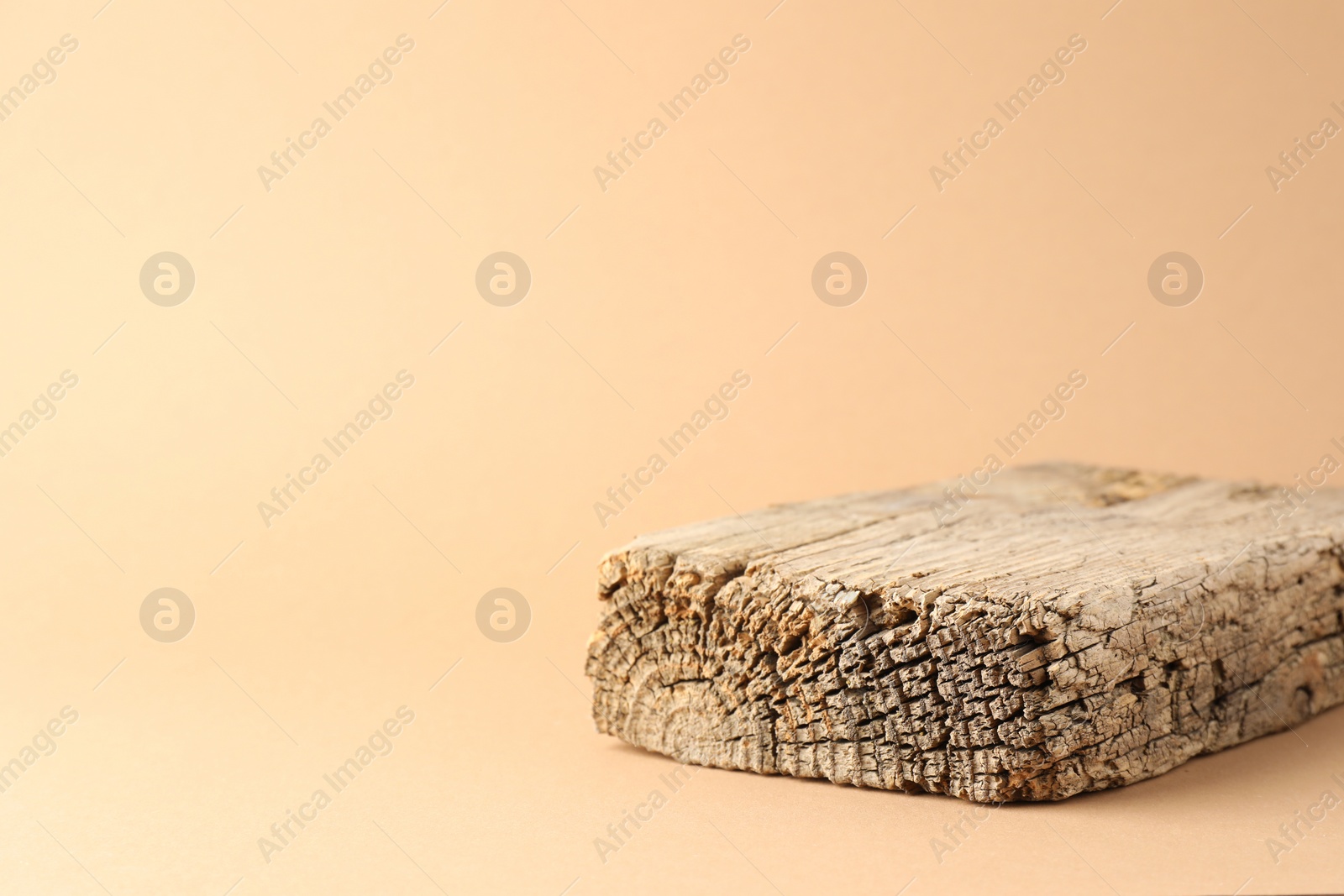 Photo of Presentation for product. Wooden podium on beige background. Space for text