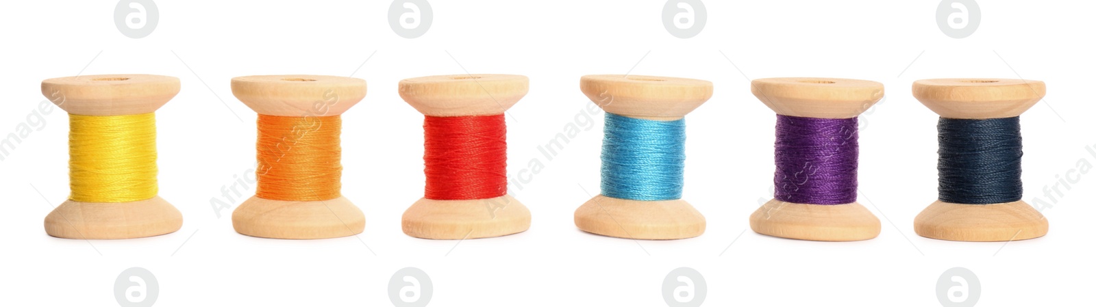 Photo of Set of colorful sewing threads on white background