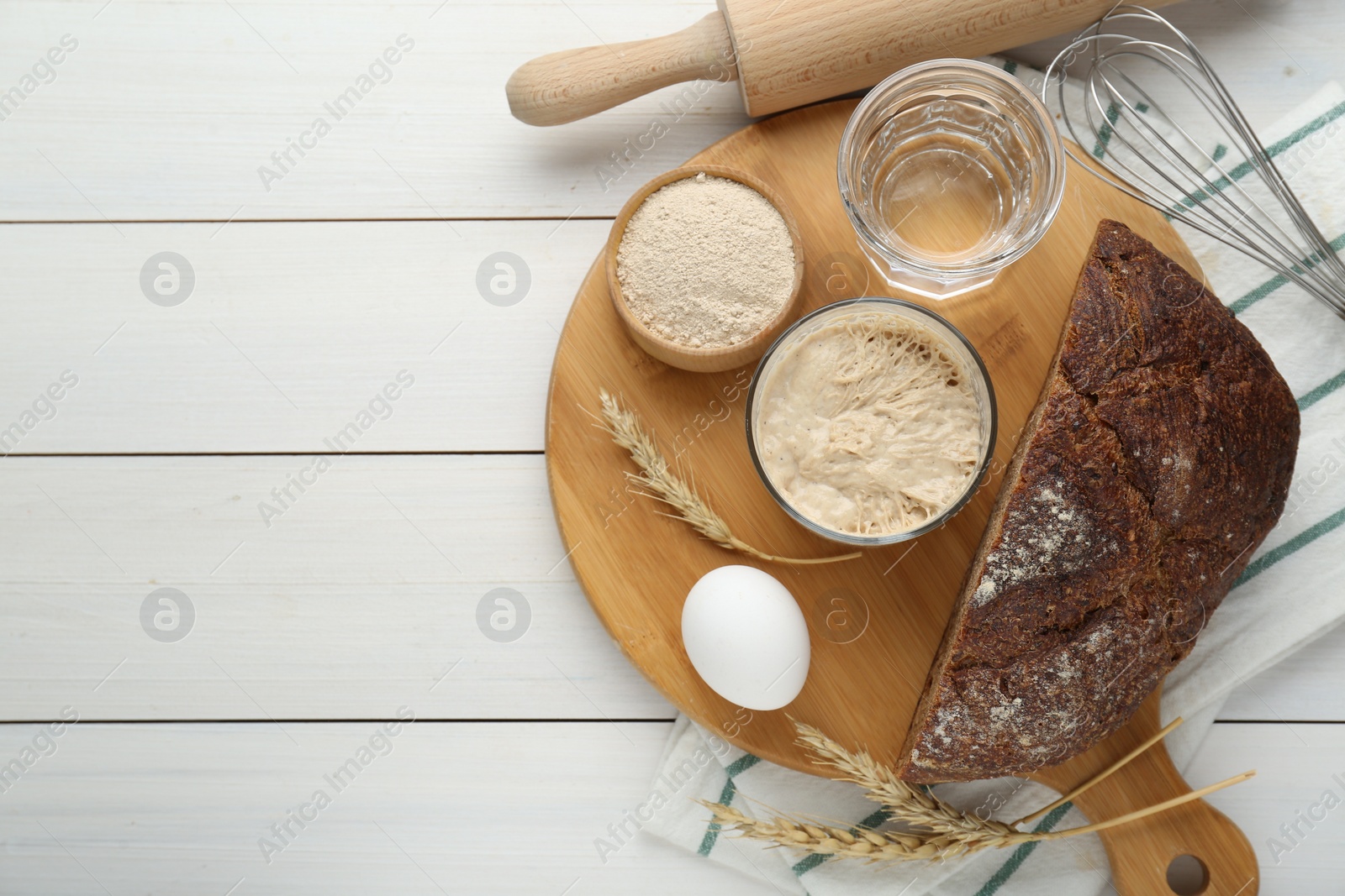 Photo of Flat lay composition with sourdough on white wooden table. Space for text