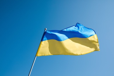 National flag of Ukraine fluttering on sunny day outdoors