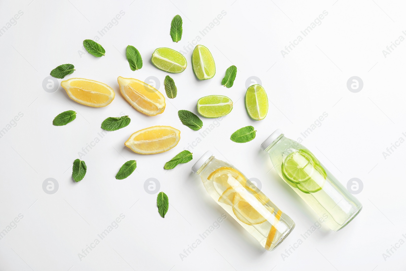 Photo of Flat lay composition with delicious natural lemonade on white background