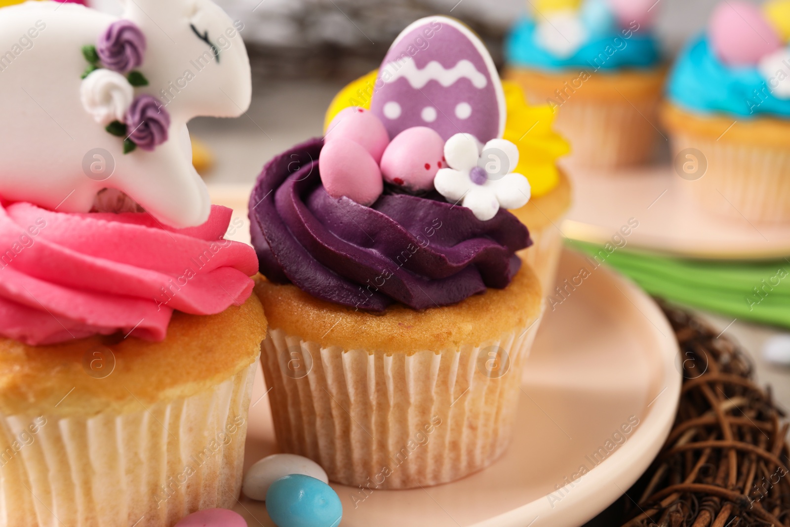 Photo of Tasty decorated Easter cupcakes on table, closeup