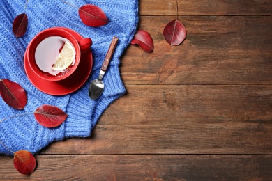 Photo of Flat lay composition with hot cozy drink and autumn leaves on wooden background. Space for text