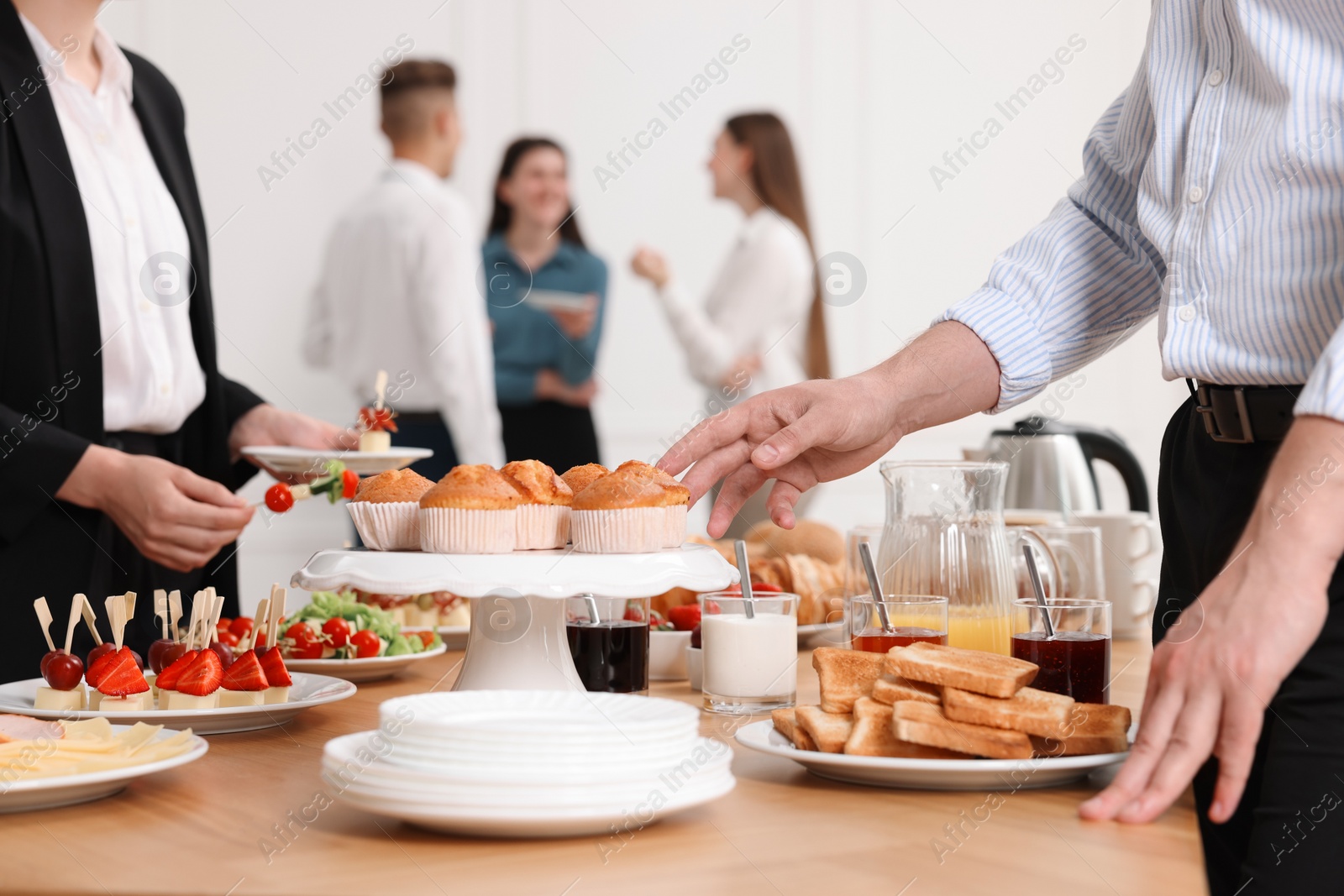 Photo of Coworkers having business lunch in restaurant, closeup