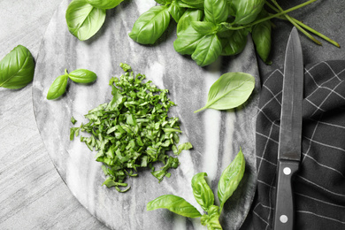 Flat lay composition with fresh basil on light grey table