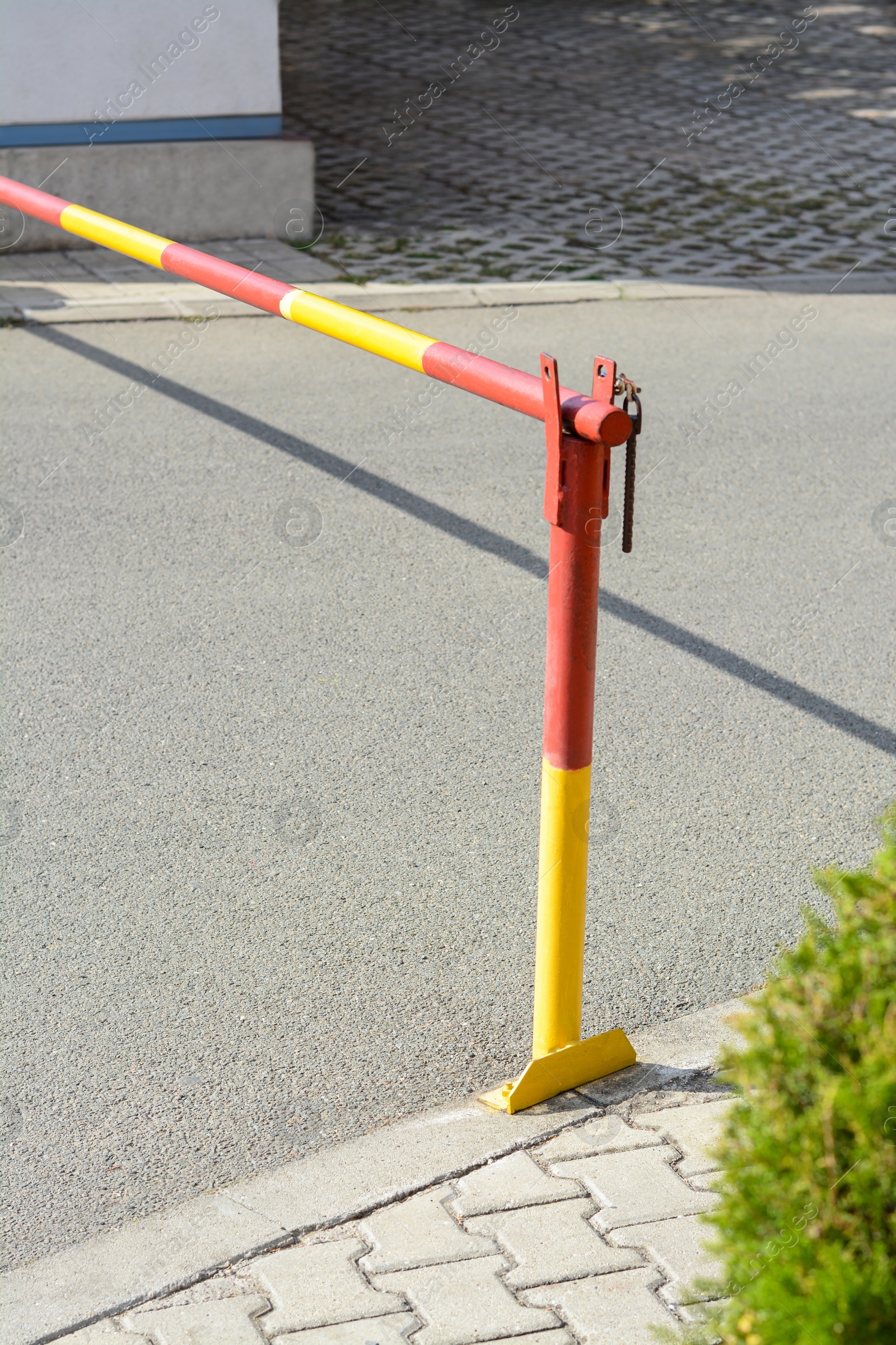 Photo of Closed boom barrier on sunny day outdoors