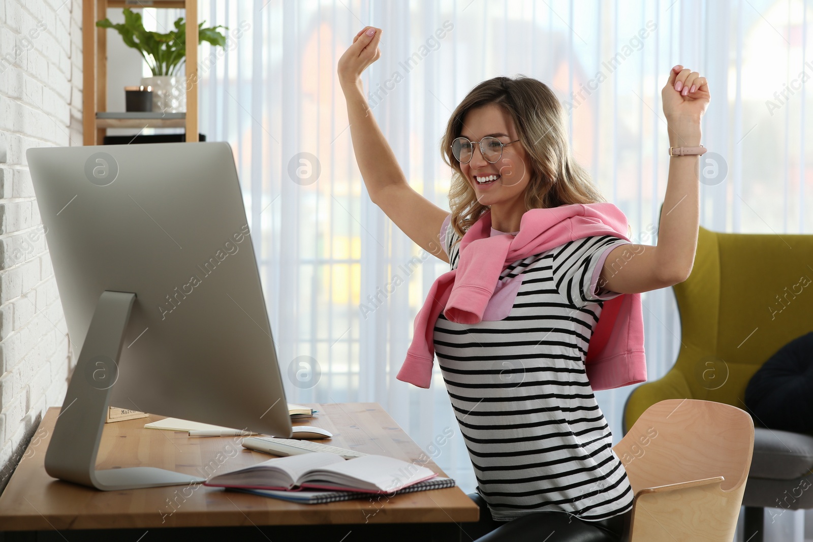 Photo of Online test. Happy woman studying with computer at home