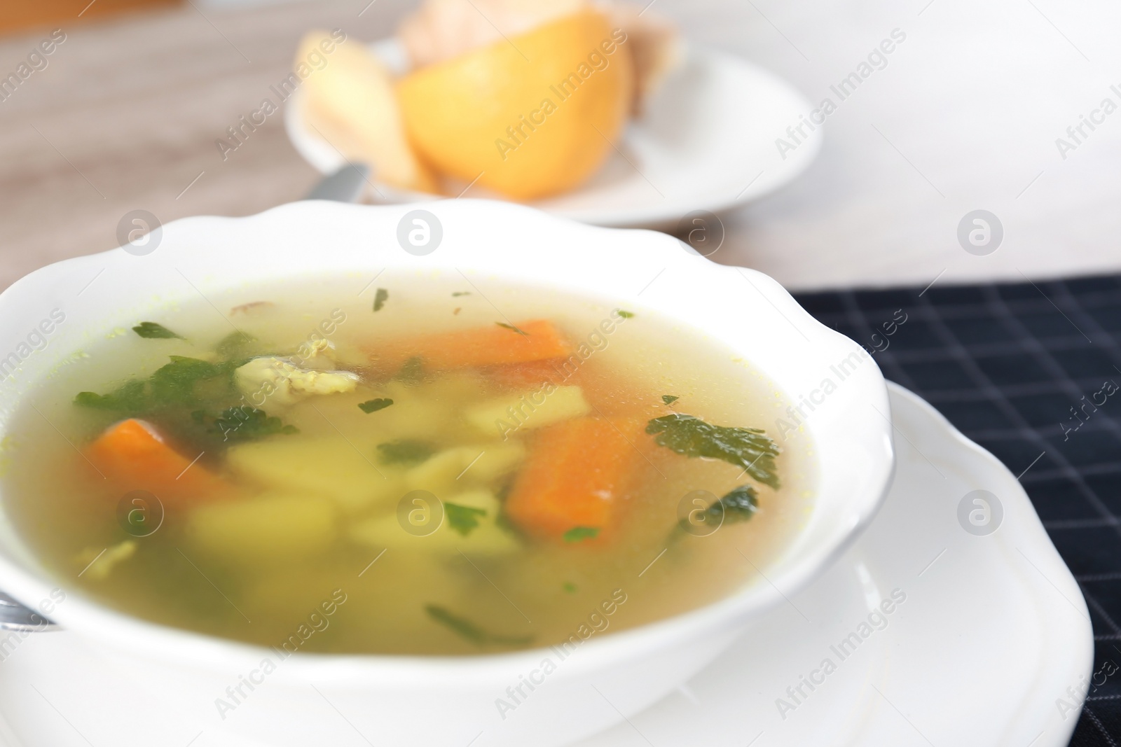 Photo of Bowl with delicious hot broth on table. Cold treatment