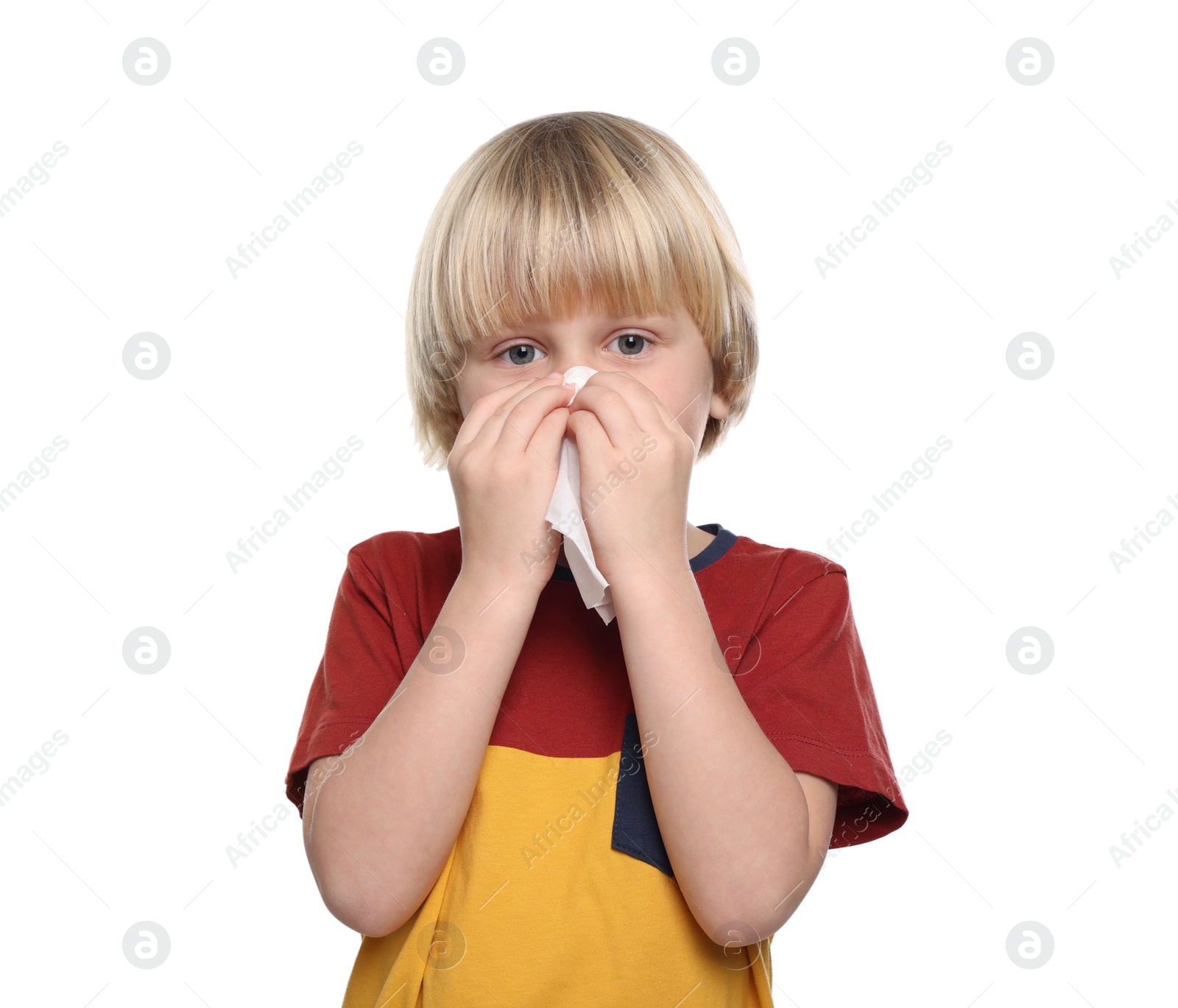 Photo of Boy blowing nose in tissue on white background. Cold symptoms