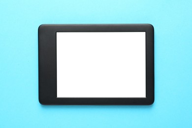 Photo of Modern e-book reader with blank screen on turquoise background, top view