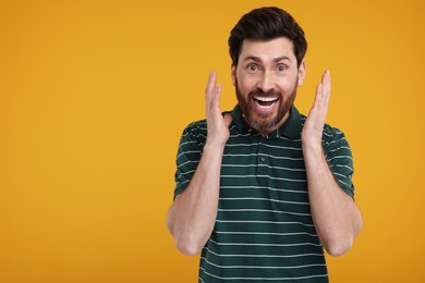 Photo of Portrait of surprised man on yellow background, space for text