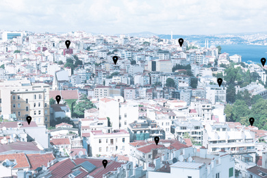 Image of Searching location. Pins above buildings in city
