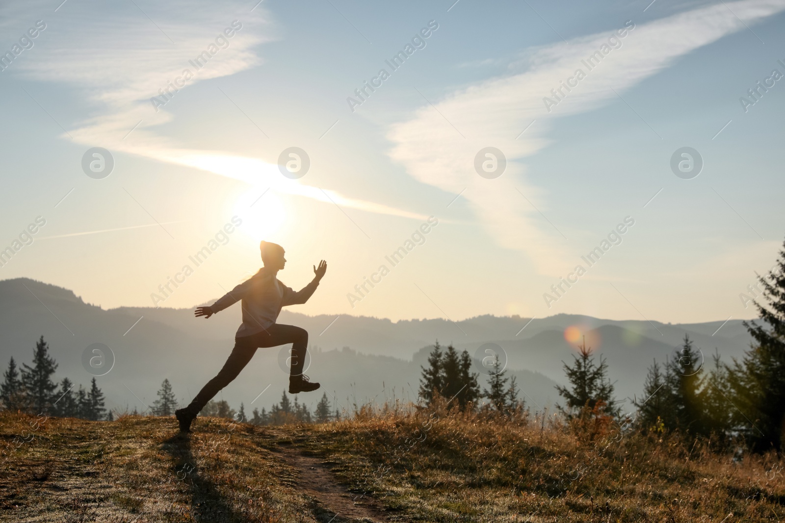 Photo of Young woman training outdoors at sunrise, space for text. Fitness lifestyle