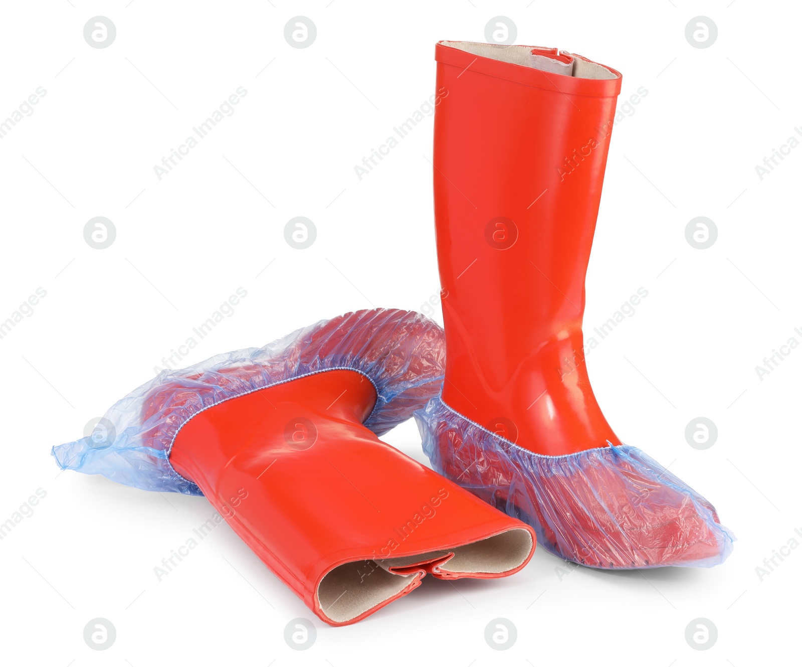 Photo of Rubber boots in blue shoe covers isolated on white