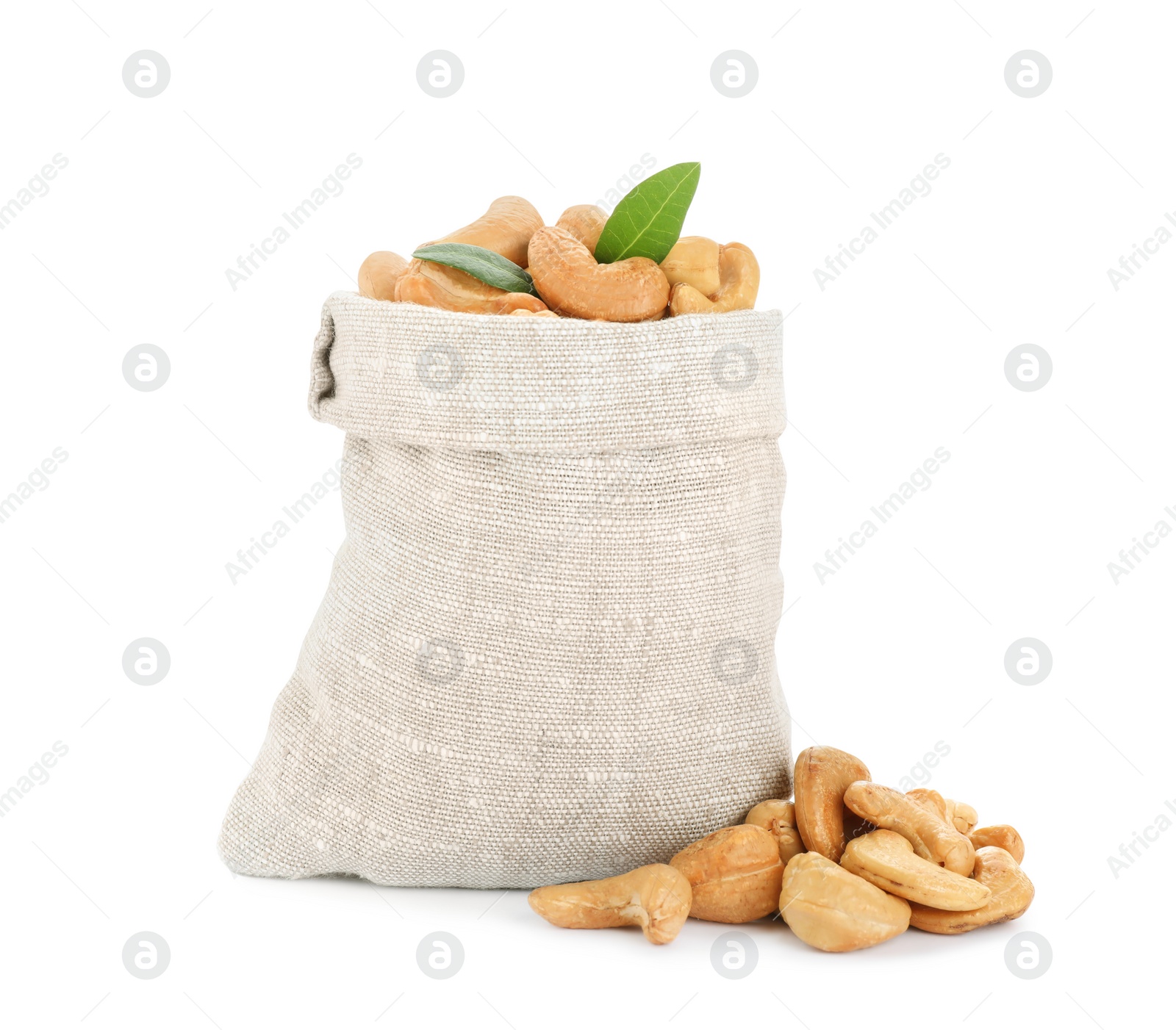 Photo of Sack, tasty organic cashew nuts and green leaves isolated on white