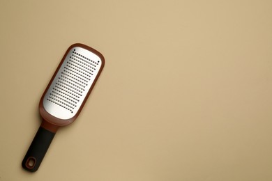 Modern grater on beige background, top view. Space for text