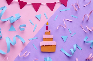 Birthday party. Paper cake and confetti on color background, flat lay