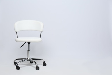 Comfortable office chair on white background, space for text