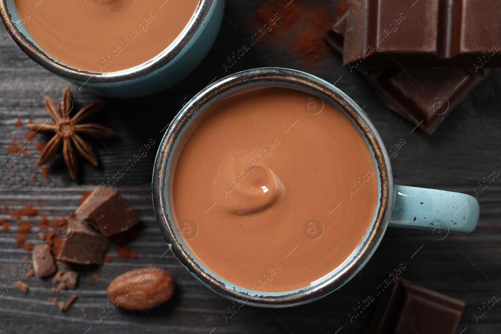 Photo of Flat lay composition with yummy hot chocolate on black wooden table