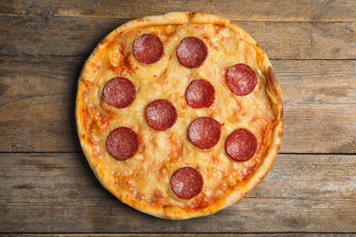 Photo of Tasty pepperoni pizza on wooden table, top view