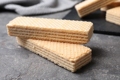 Delicious cream wafers on grey table, closeup