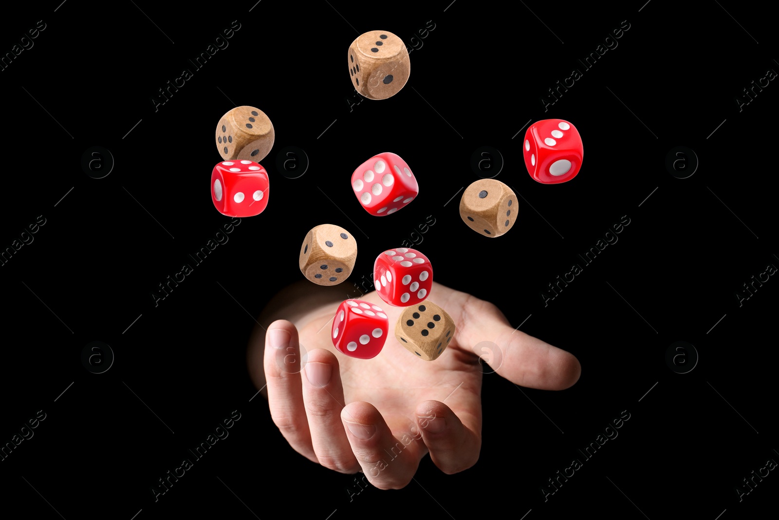 Image of Man throwing dice on black background, closeup