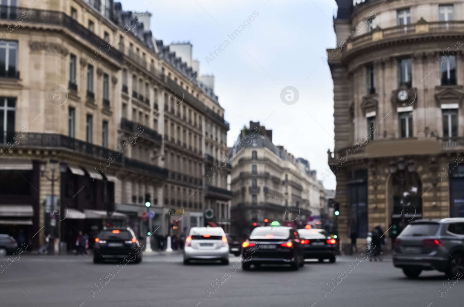 Photo of Blurred view of street with beautiful buildings and cars