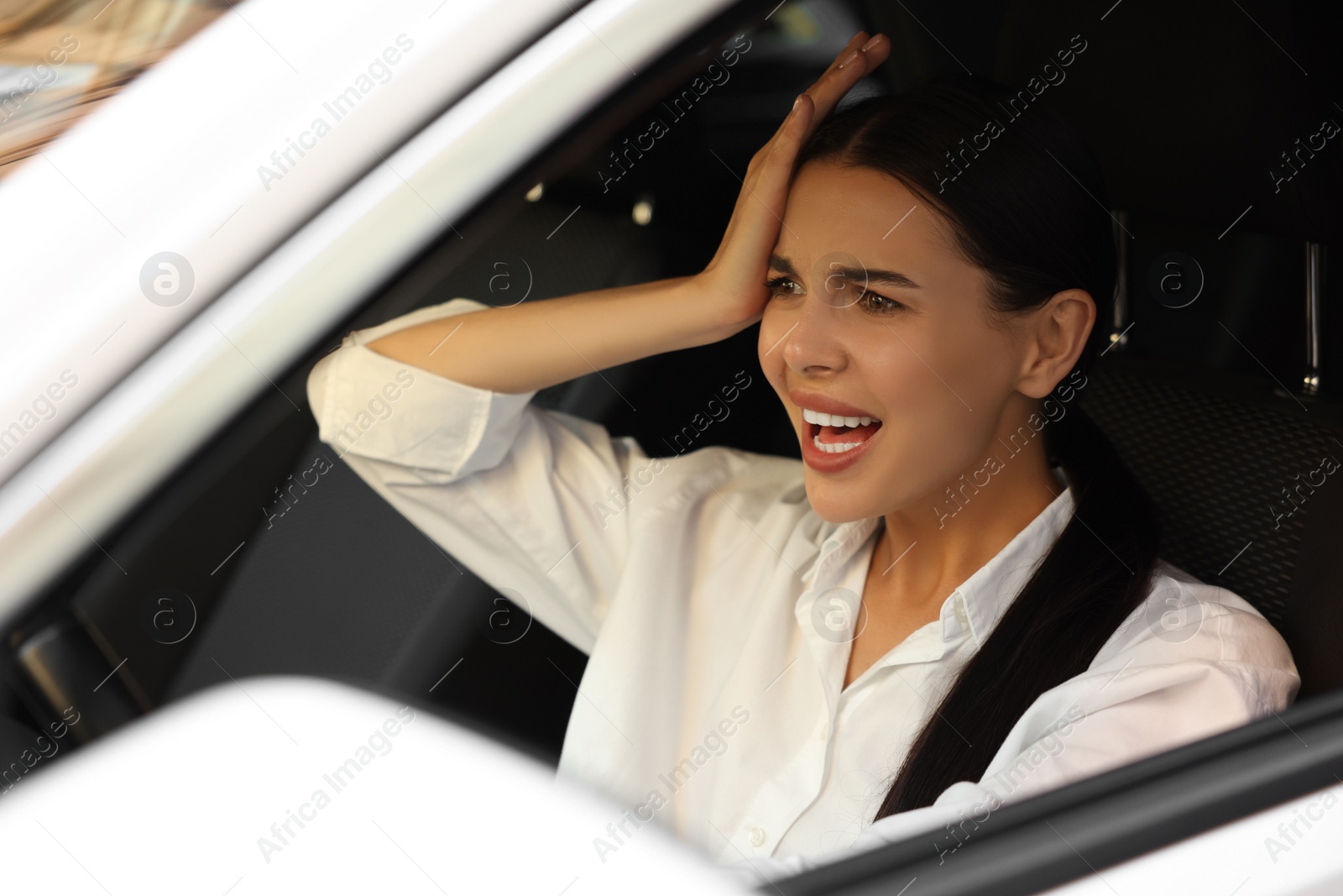 Photo of Stuck in traffic jam. Angry driver in her car, view from outside