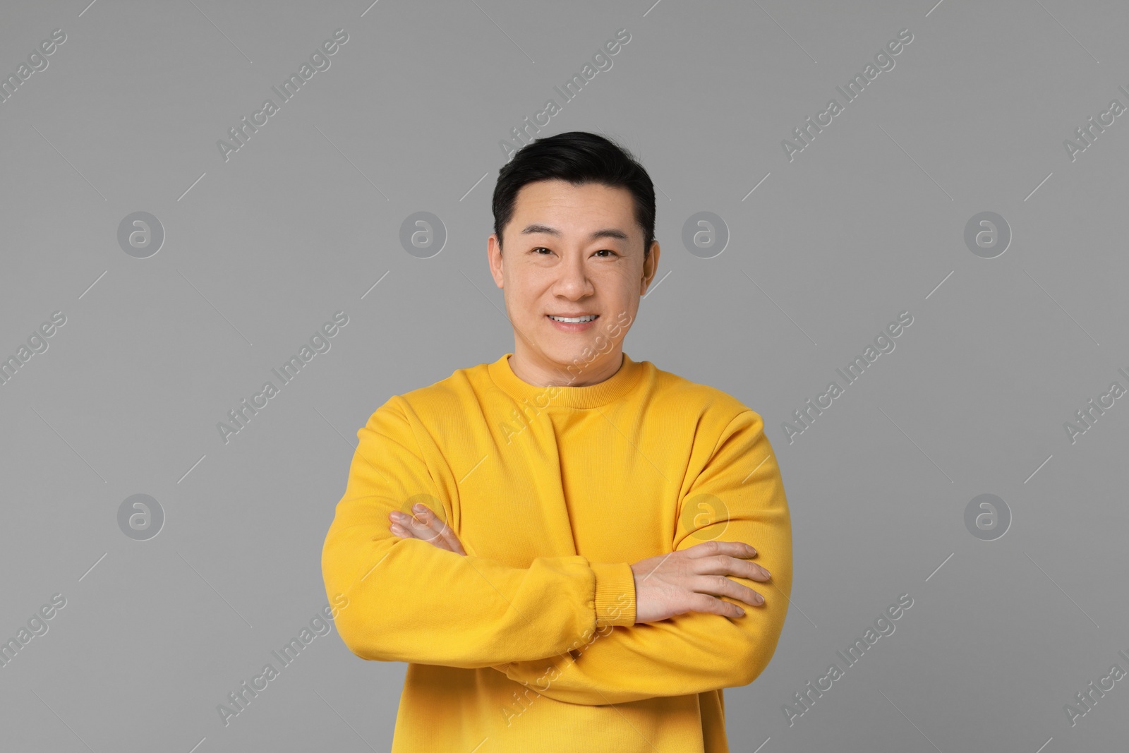 Photo of Portrait of happy man on grey background