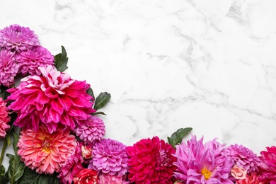Photo of Flat lay composition with beautiful dahlia flowers on white marble background. Space for text
