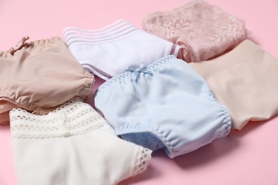 Photo of Stylish folded women's underwear on pink background, closeup