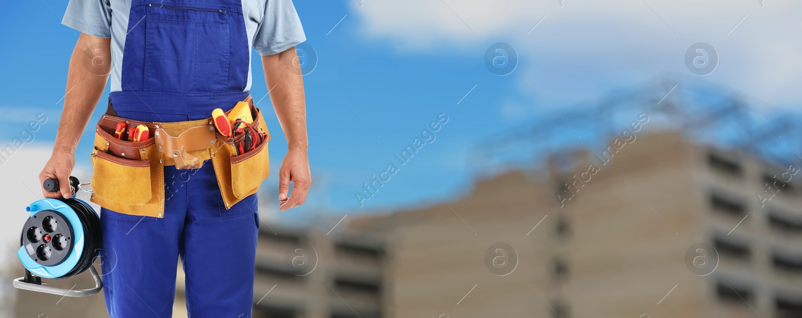 Image of Closeup view of electrician with tools at site, space for text. Banner design