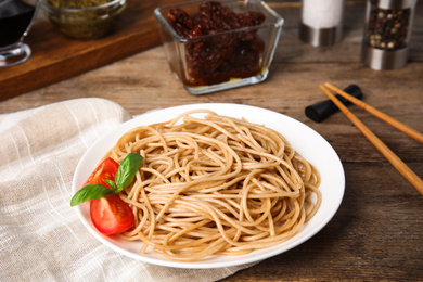 Tasty buckwheat noodles served on wooden table