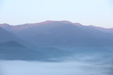 Photo of Beautiful view of fog in mountains during sunrise