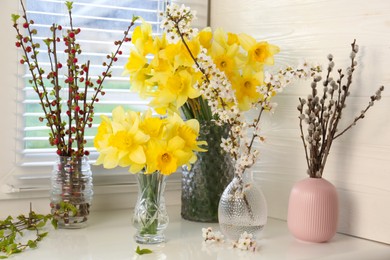 Yellow daffodils and beautiful branches on windowsill