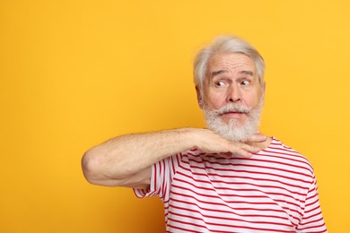 Photo of Senior man with mustache on orange background