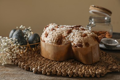 Photo of Delicious Italian Easter dove cake (traditional Colomba di Pasqua) on wooden table