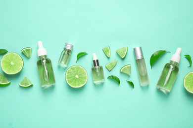 Flat lay composition with lime essential oil on light turquoise background