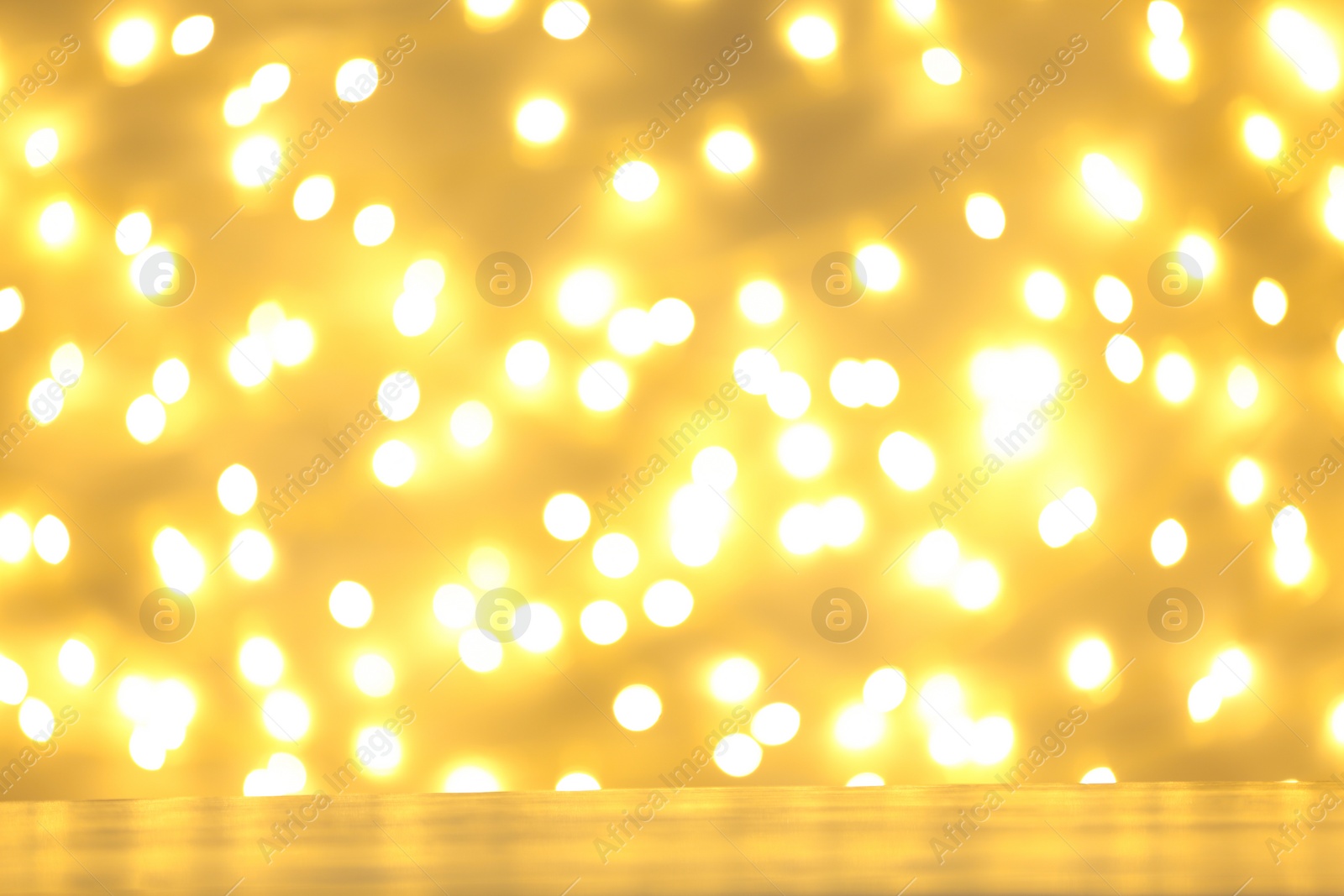 Photo of Empty table against golden bokeh background. Mockup for design