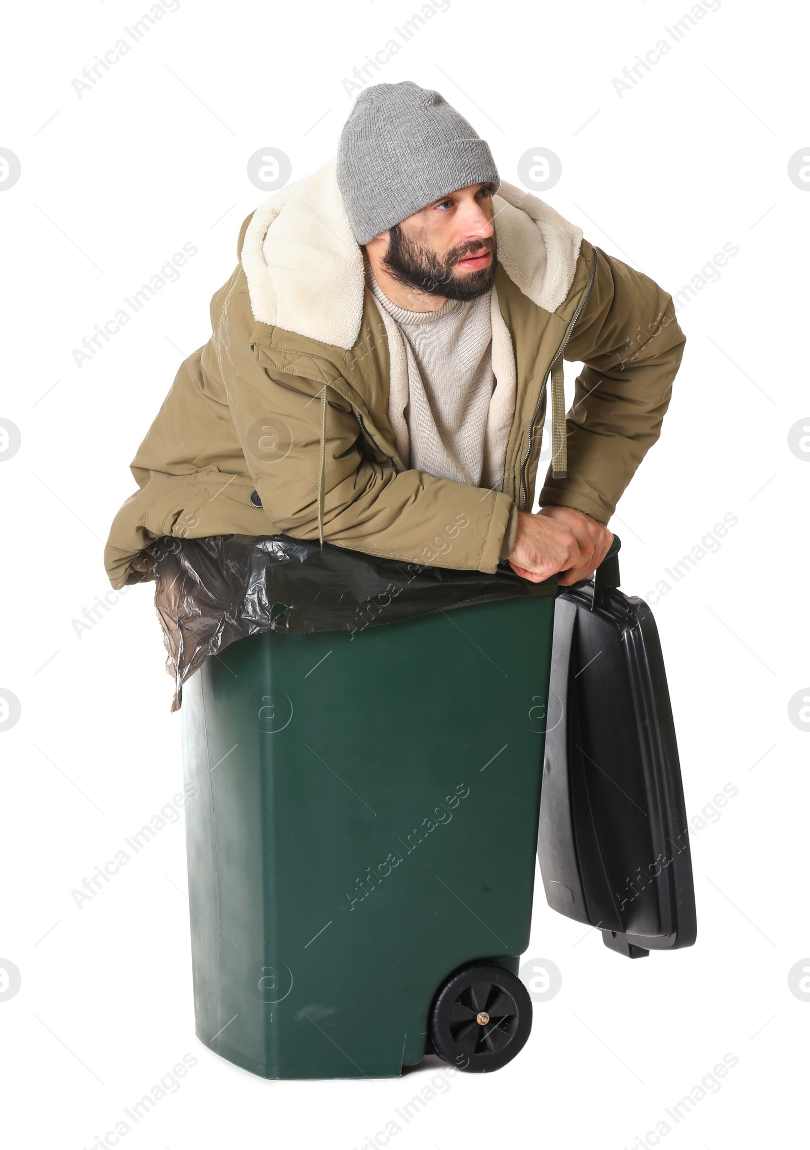 Photo of Poor homeless man in trash bin isolated on white
