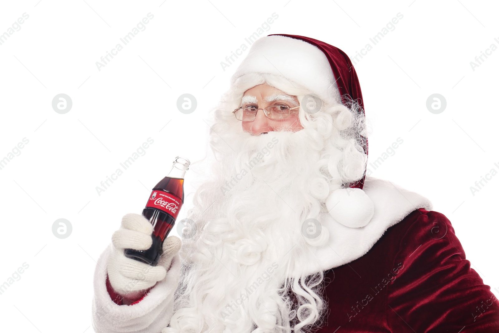 Photo of MYKOLAIV, UKRAINE - JANUARY 18, 2021: Santa Claus holding Coca-Cola bottle on white background