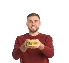 Young man with tasty burger on white background