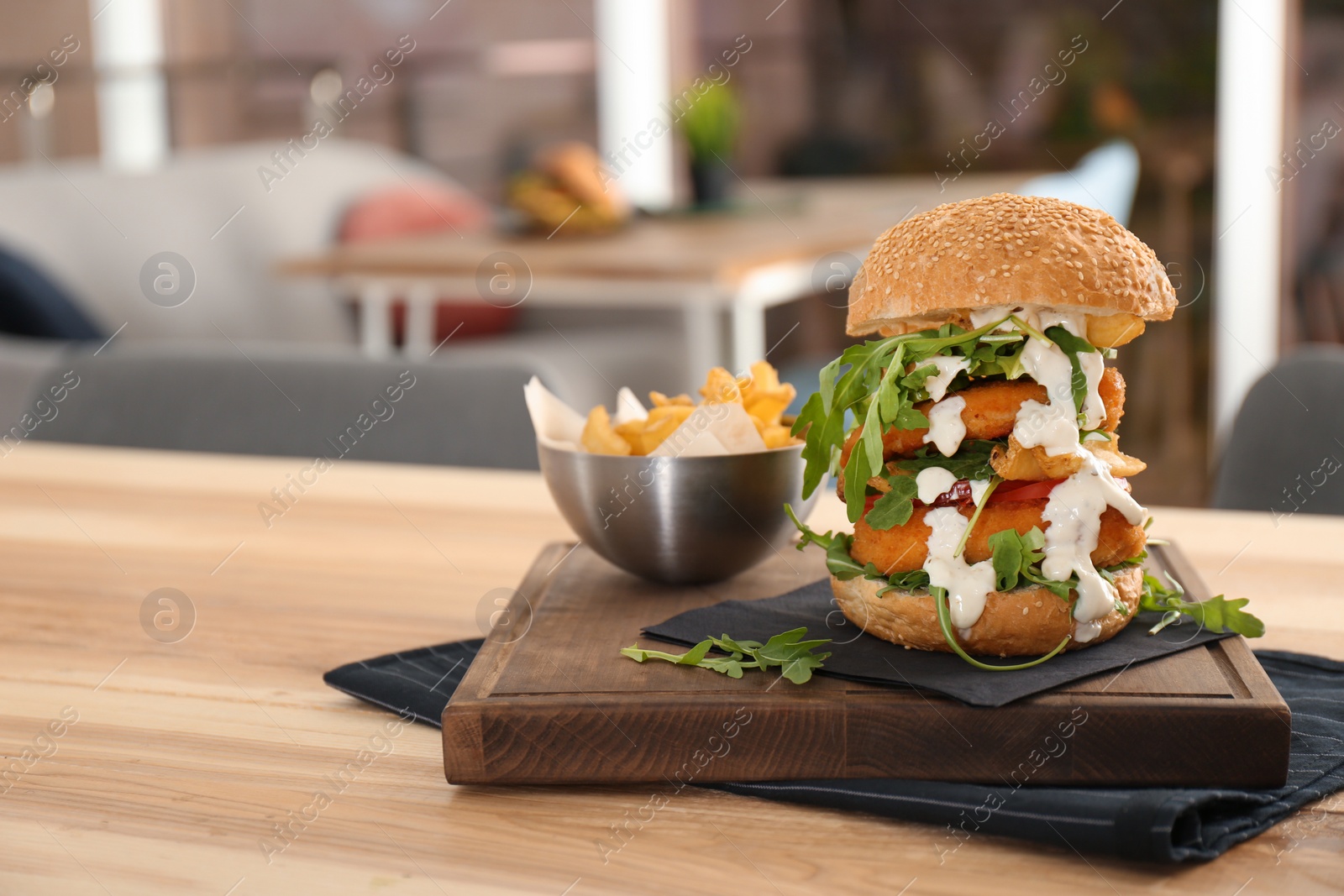 Photo of Huge yummy burger served on table in cafe. Space for text